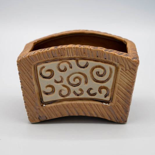 Ceramic container with decorative patterns on a white background