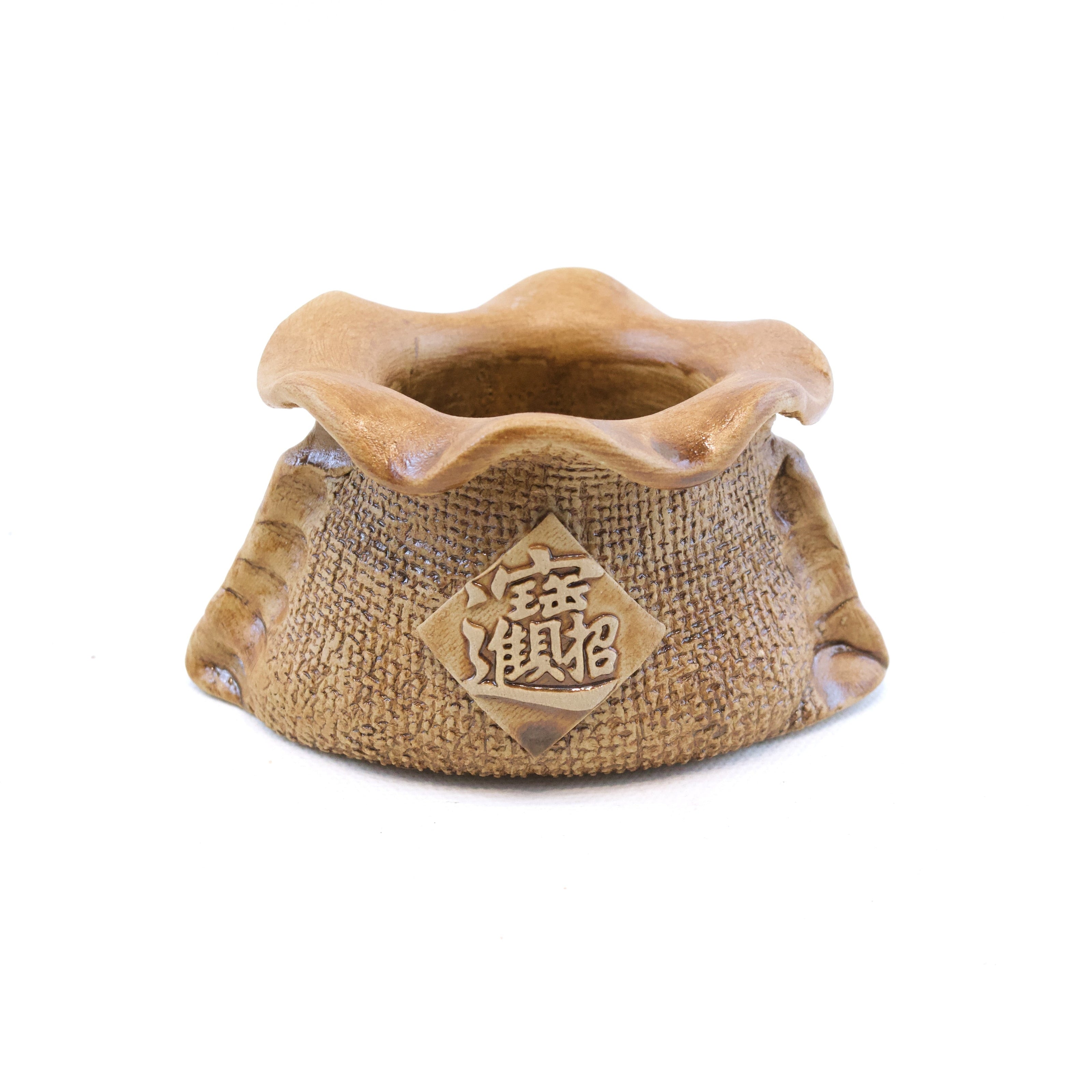 Ceramic incense burner with a textured design on a white background