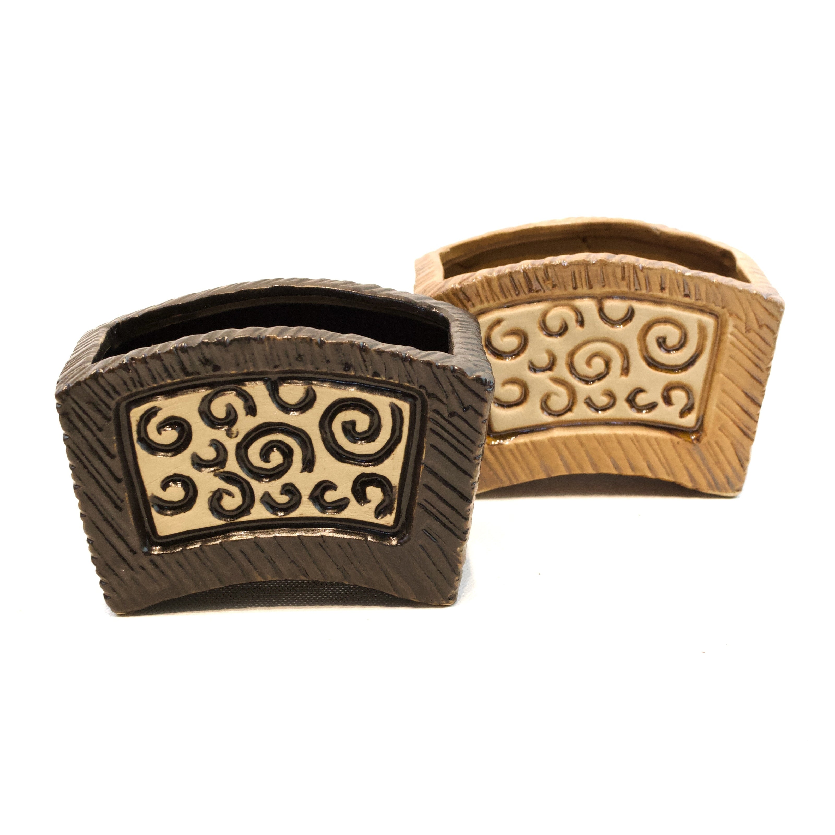 Two decorative items with intricate patterns on a white background