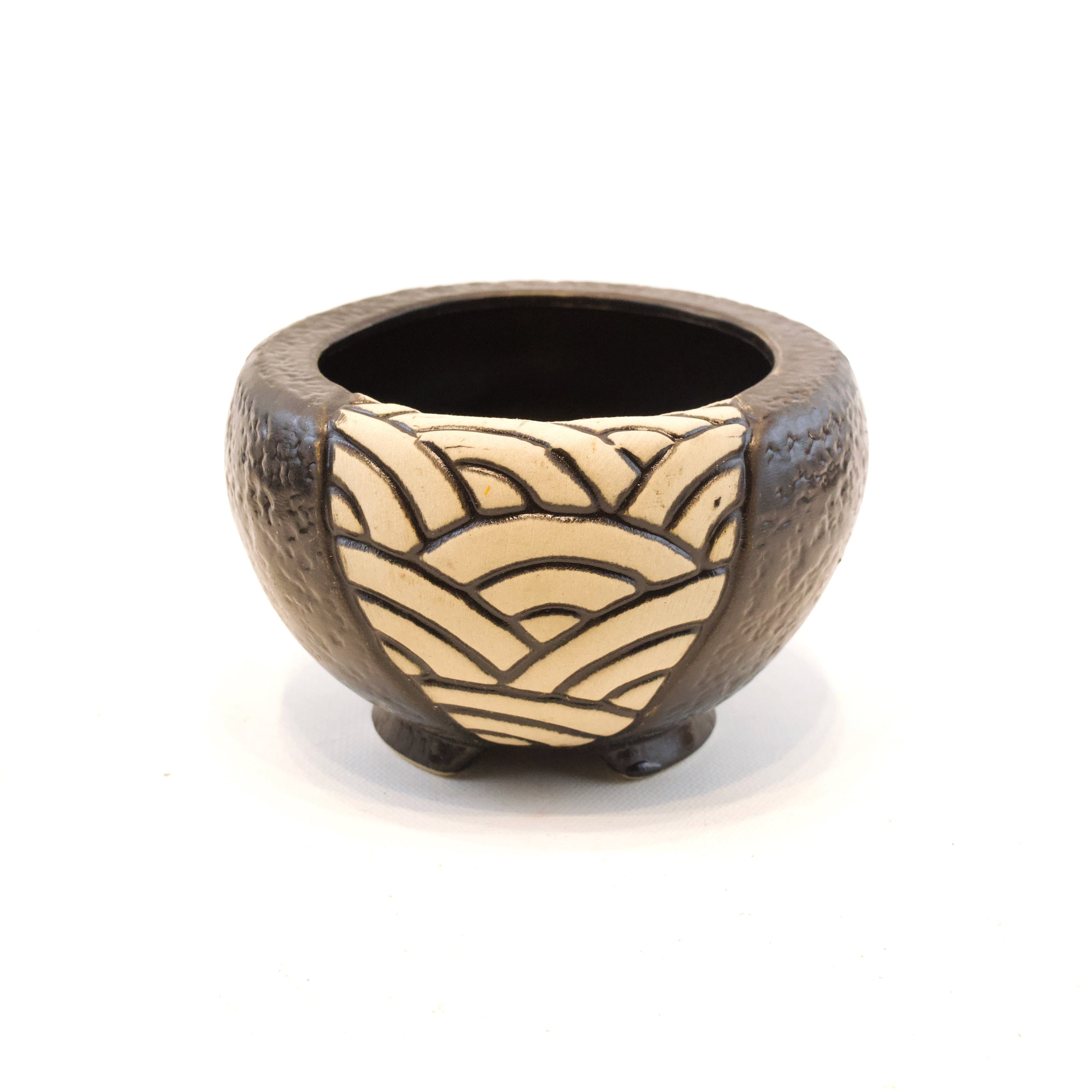 Ceramic bowl with wavy pattern on a white background