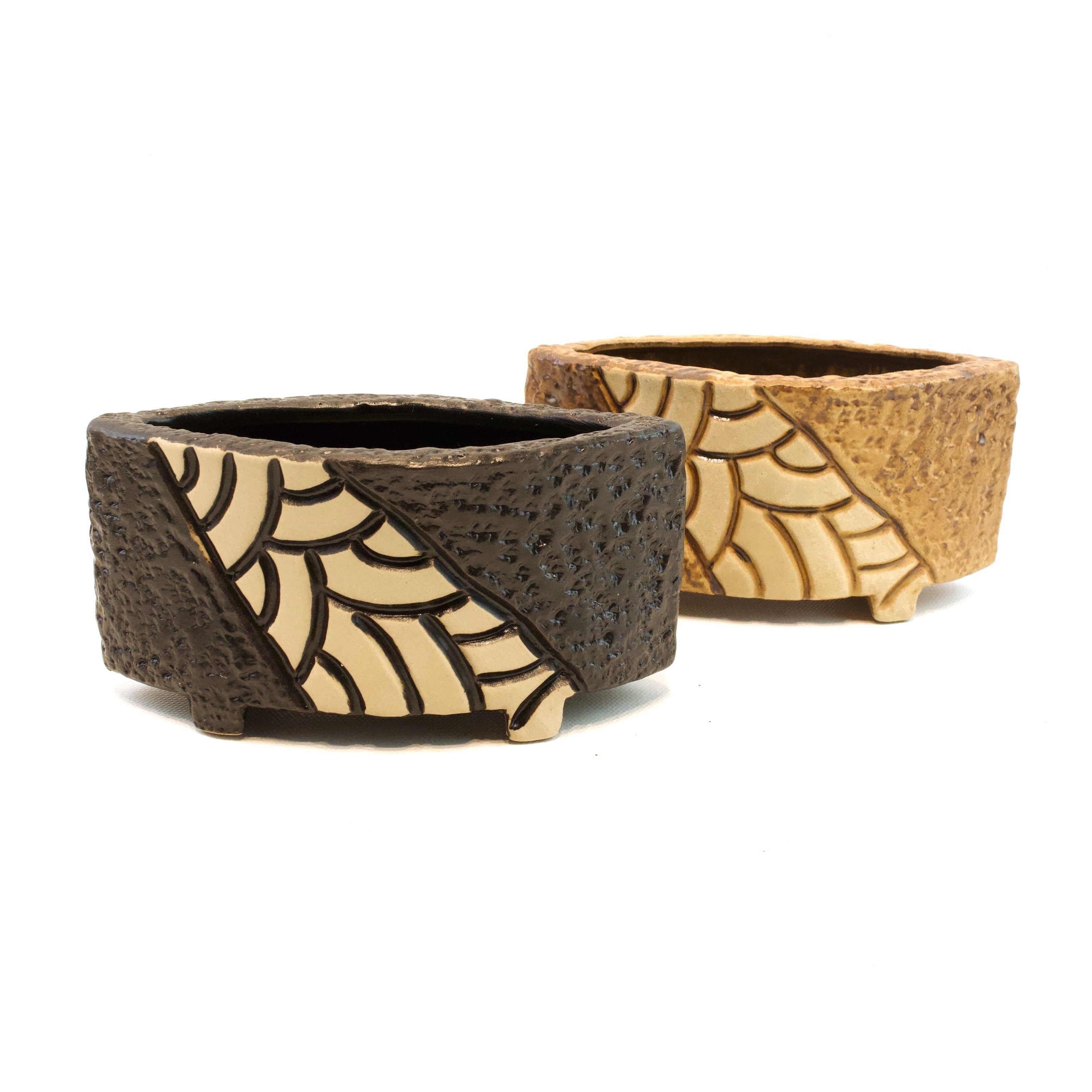 Two woven baskets with a geometric pattern on a white background