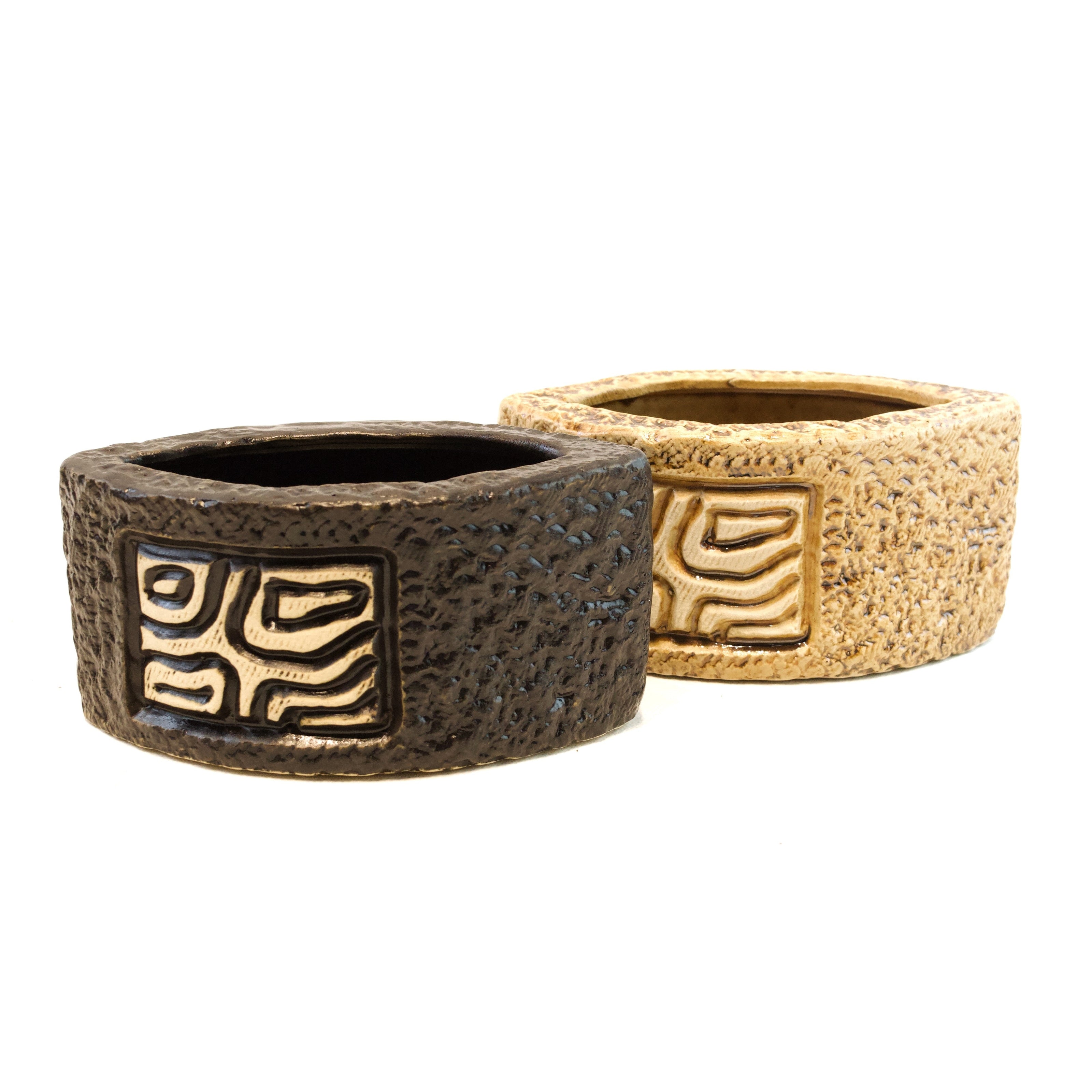 Two brown ceramic planters with textured surface and geometric patterns on a white background