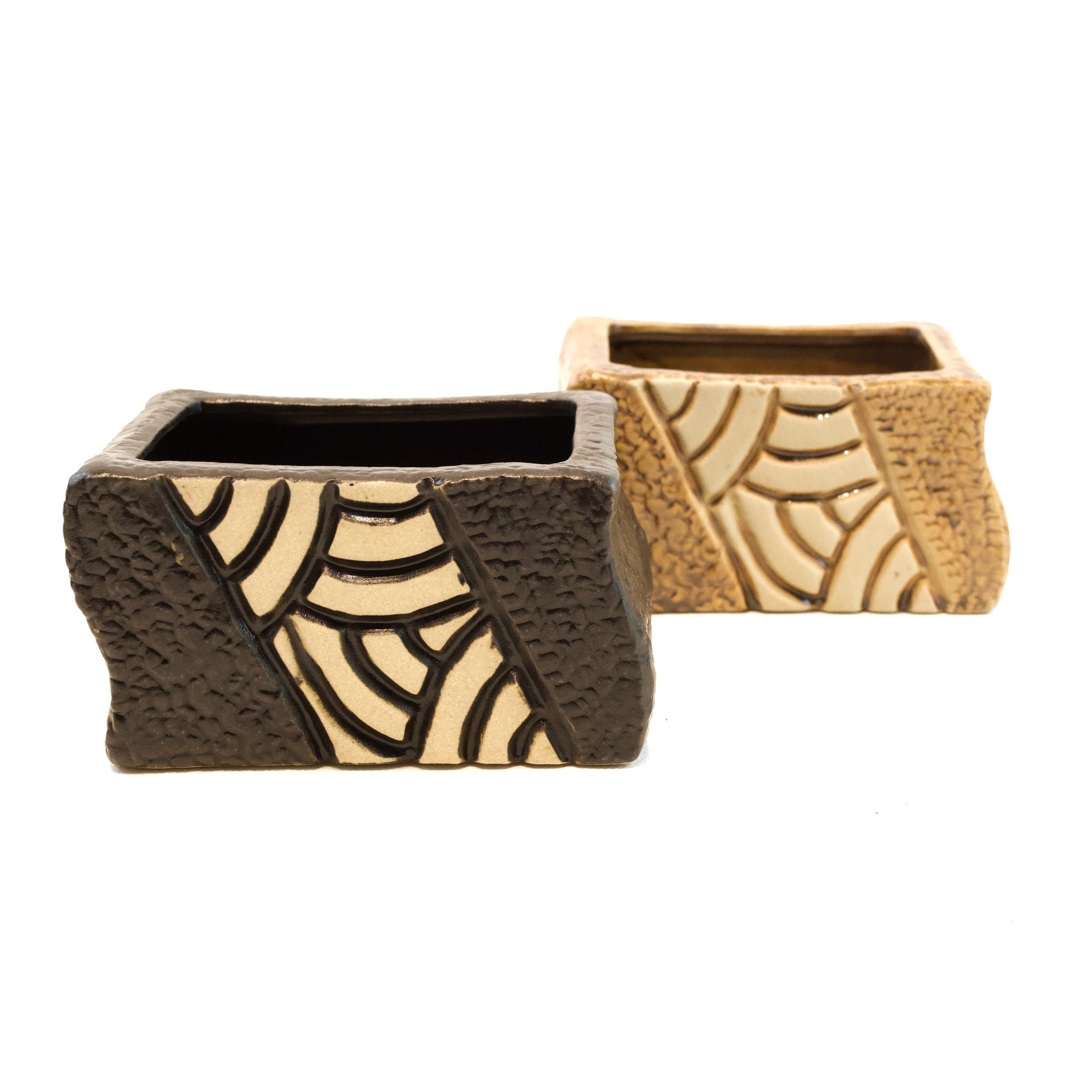 Two decorative boxes with spider web patterns on a white background