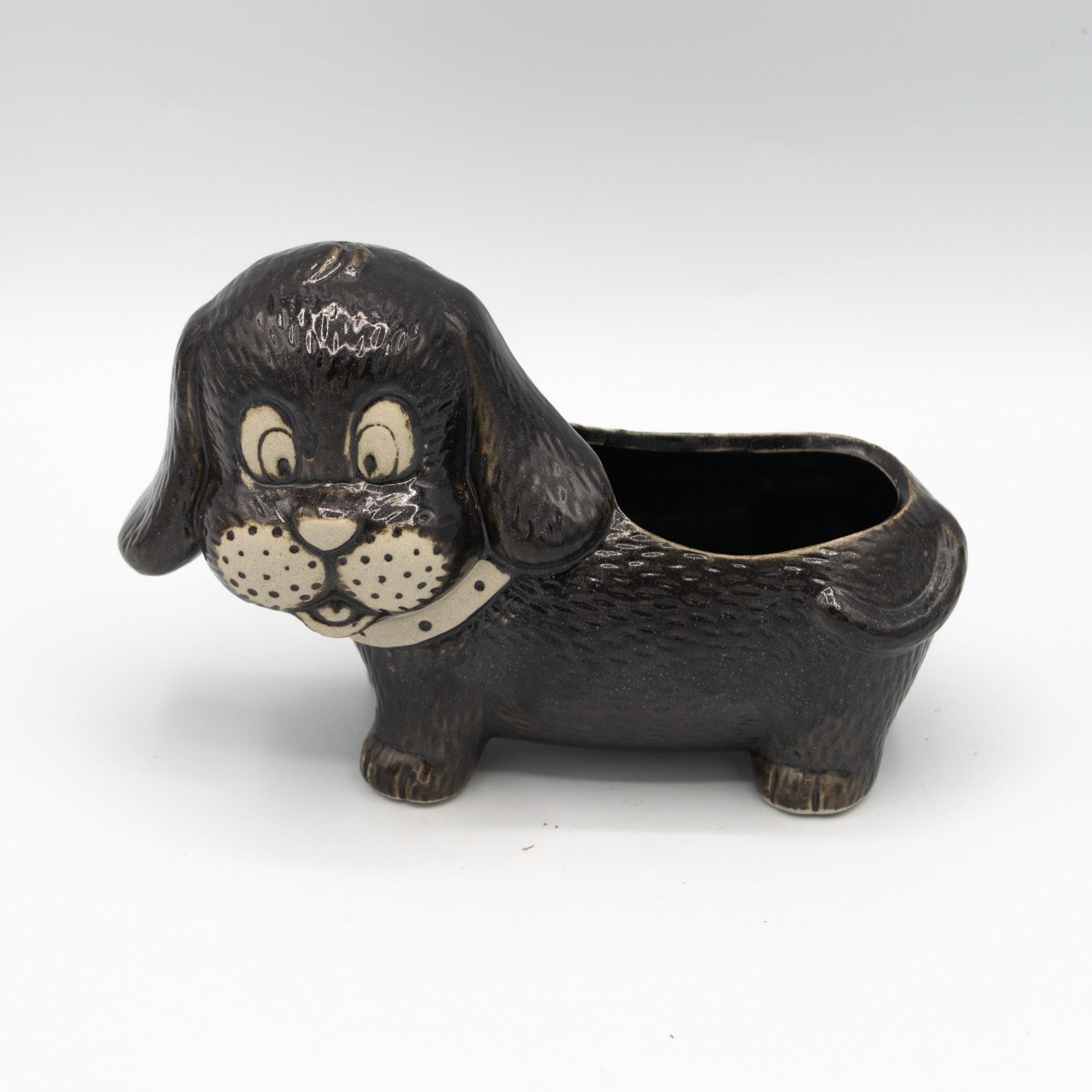 Dog-shaped planter on a white background