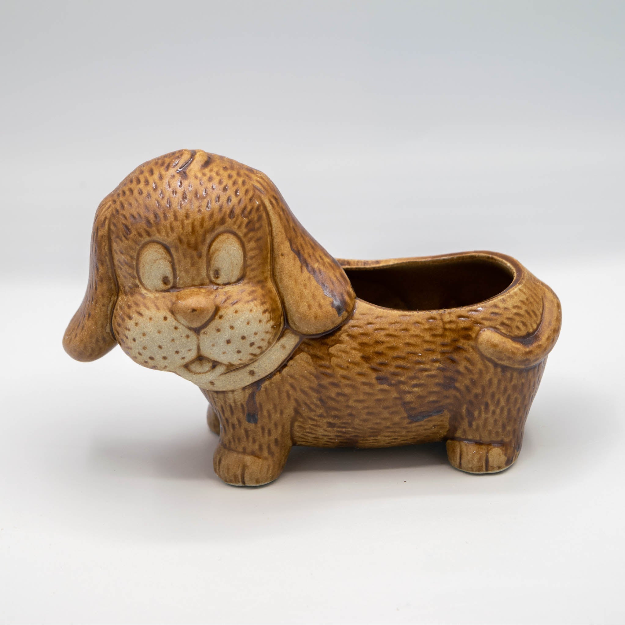 Ceramic dog-shaped planter on a white background