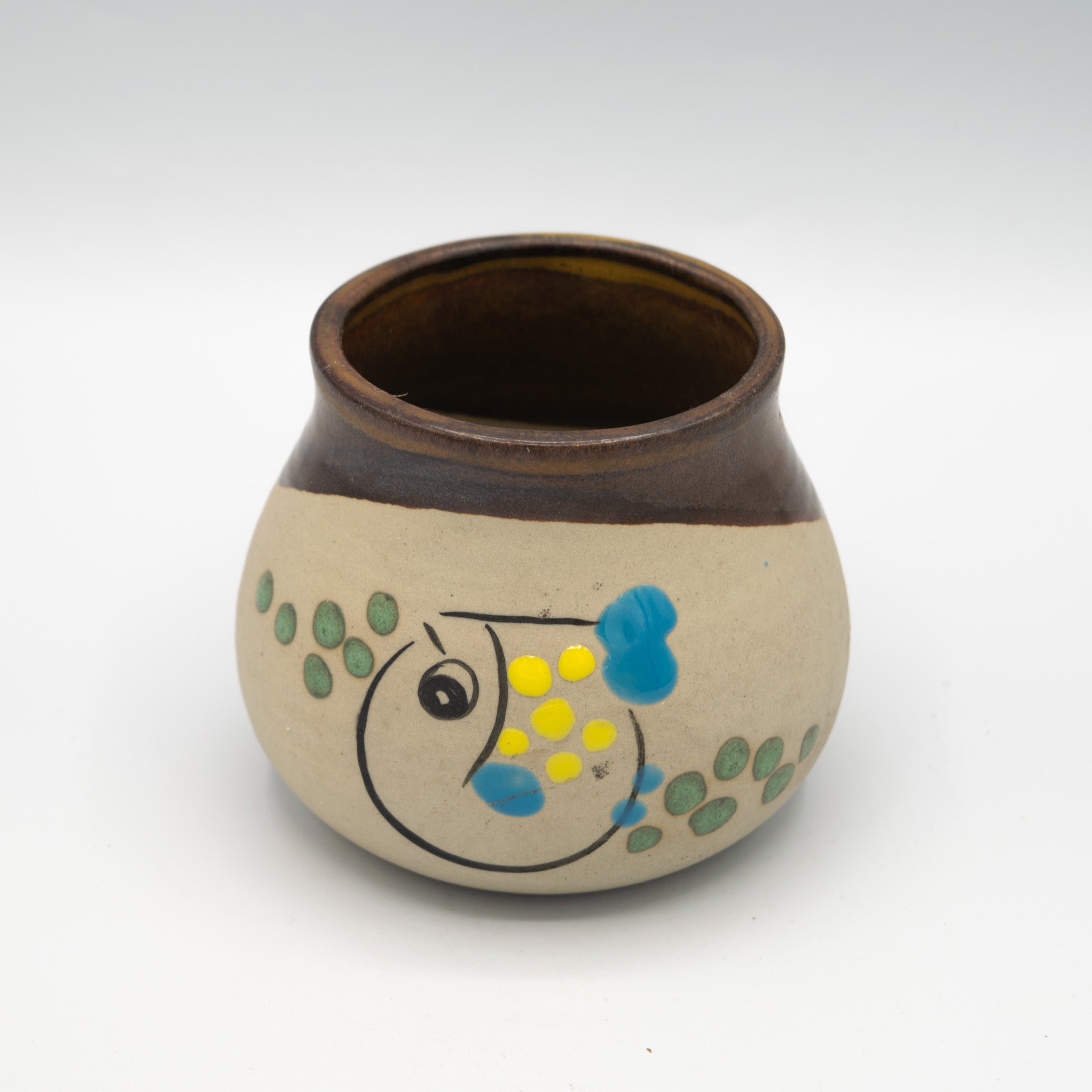 Ceramic jar with fish design on a white background