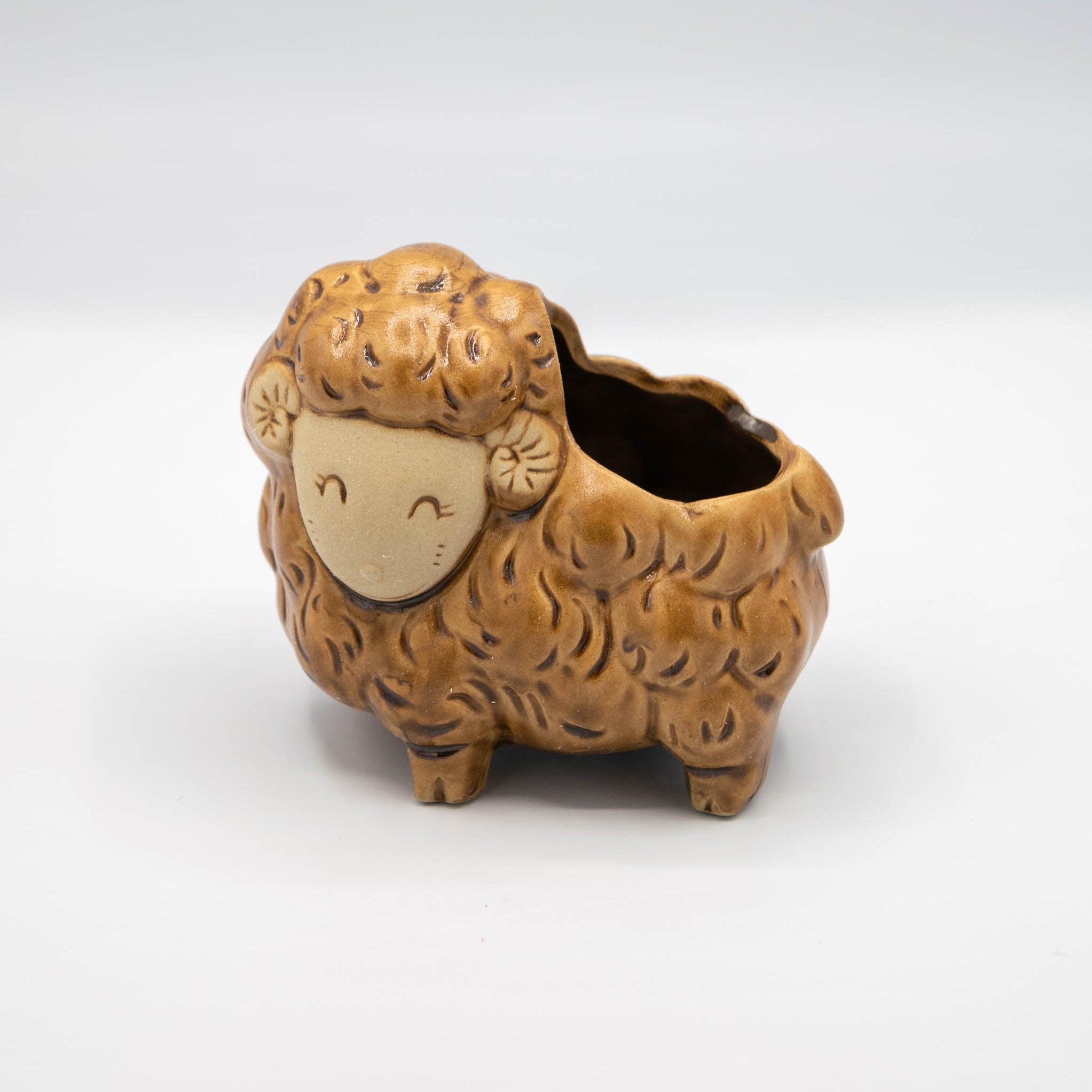 Ceramic sheep-shaped planter on a white background