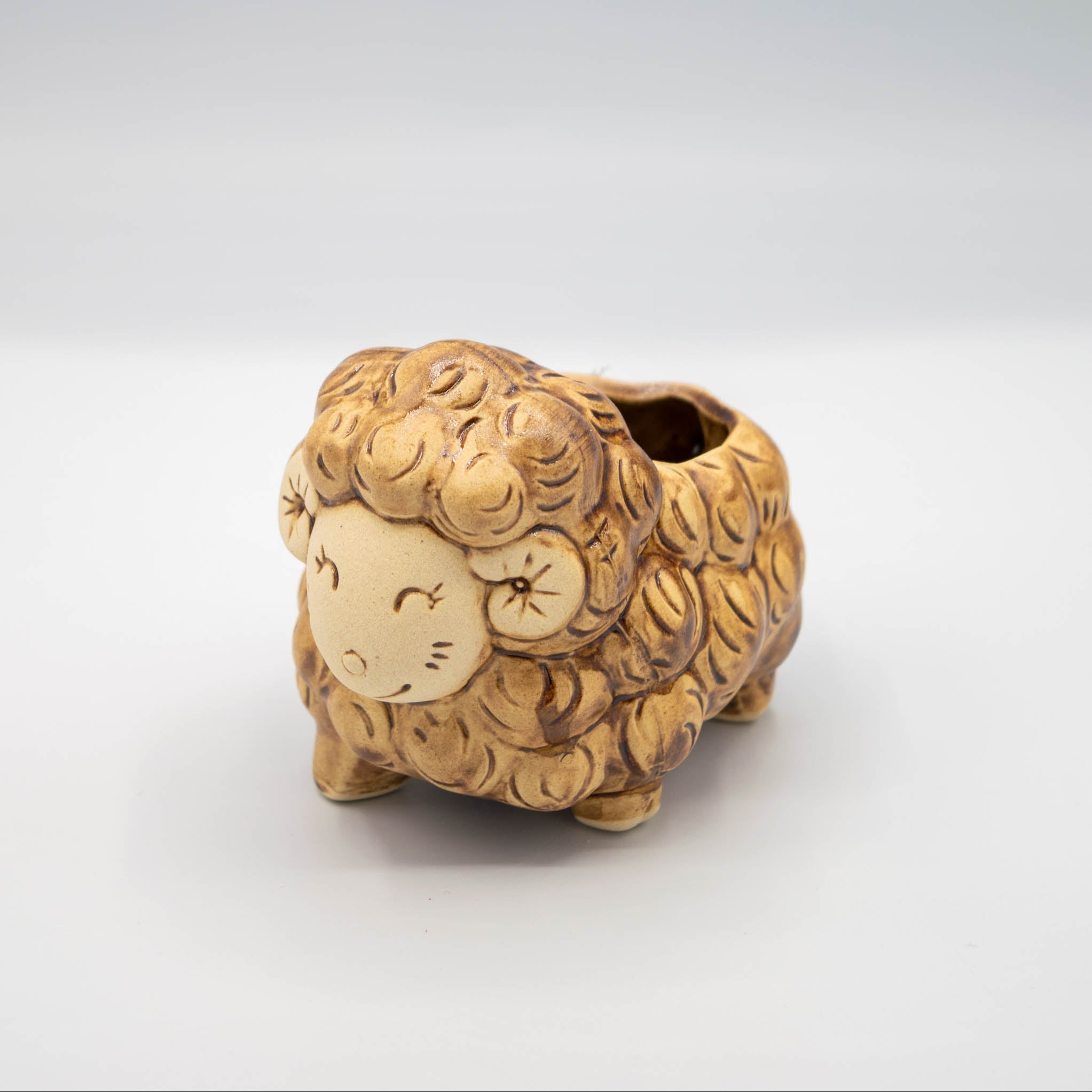 Ceramic sheep-shaped planter on a white background