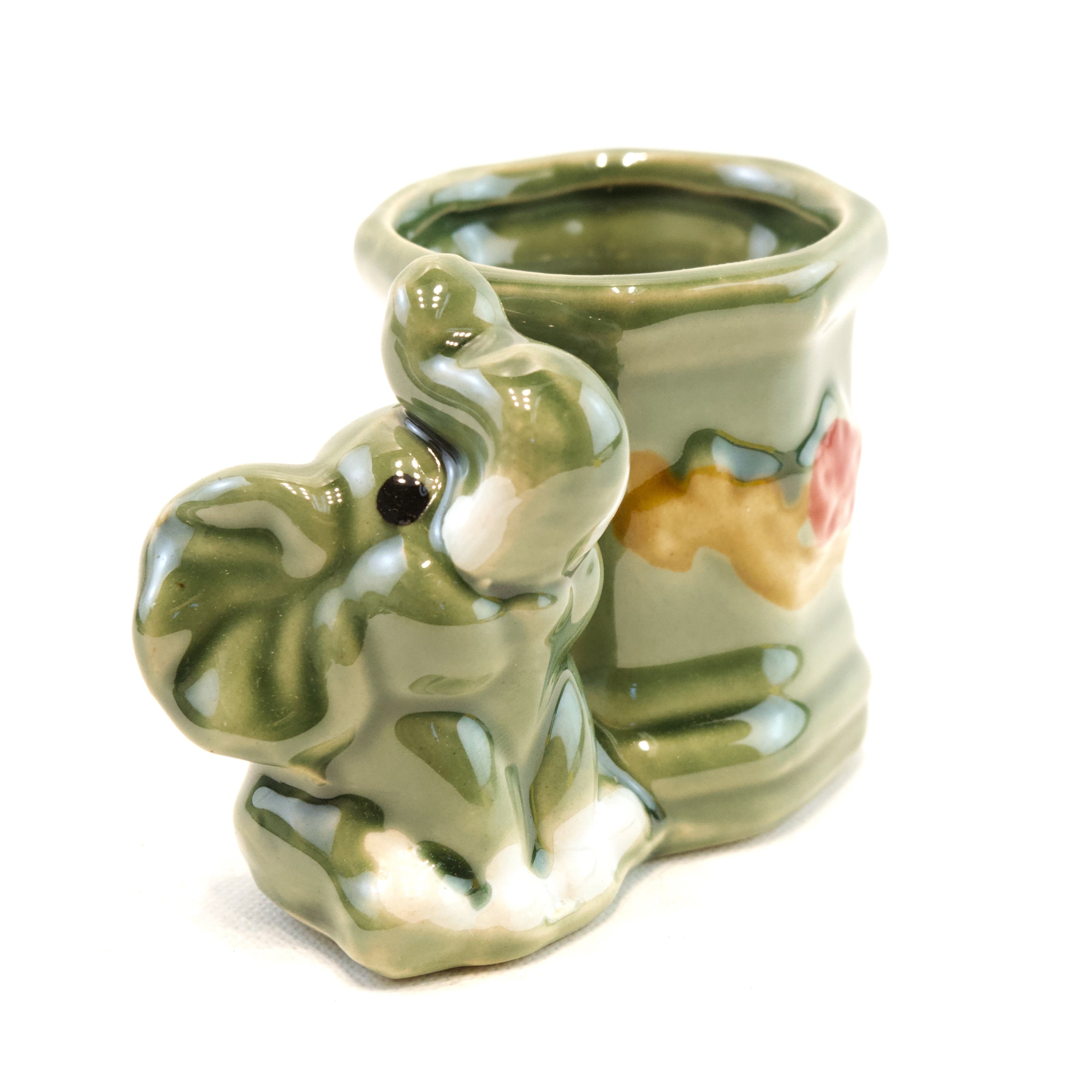 Ceramic elephant-shaped vase with a white background