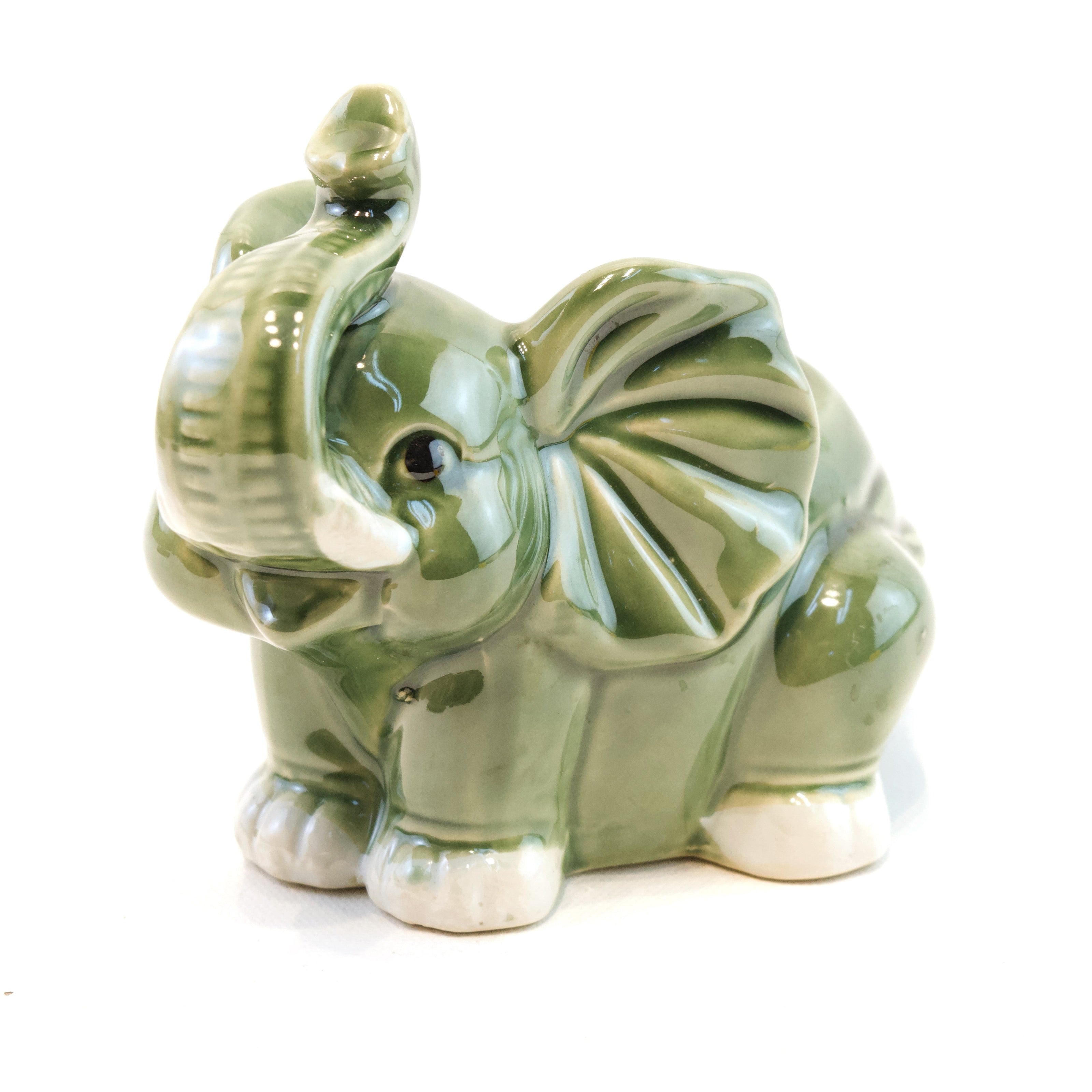 Green ceramic elephant on a white background