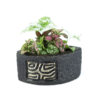 planter with a mosaic design in the front with a pot shaped like a fin.