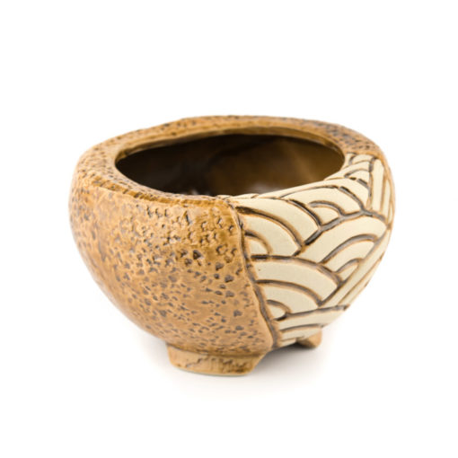 A picture of a side view of a mosaic design round brown planter.